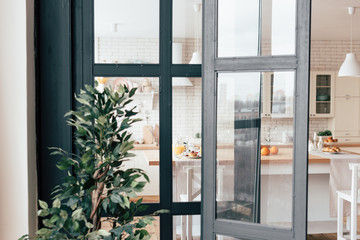 open kitchen windows, served table with food and green plant