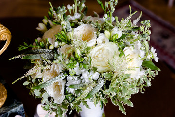 Creme roses combined with snow-white freesia in a wedding bouquet