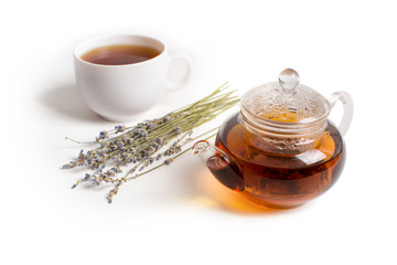 Teapot and lavender on the white table.