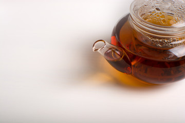 Teapot with black tea.
