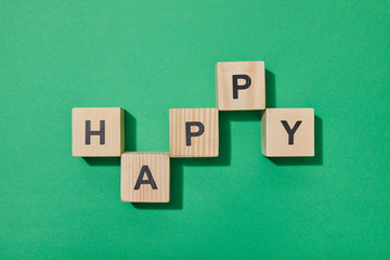 top view of wooden blocks with letters on green surface