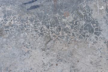 Grunge concrete wall with crack and stains in industrial building. Cement texture for design and background.