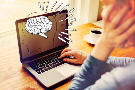 Brain illustration with man using a laptop computer