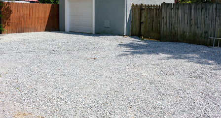 New gravel driveway in rear of residential home. - obrazy, fototapety, plakaty