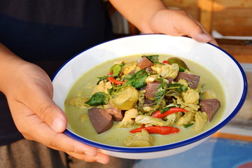 Thai food called Gang Keow Wan; green curry in the white bowl 