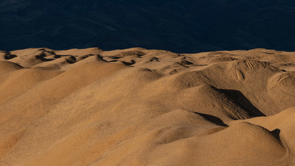 Sun and shade on sand/gravel quarry hills