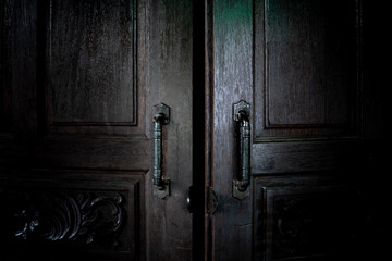 Old wooden doors to dark rooms