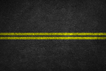 Structure of granular asphalt. Asphalt texture with two yellow line road marking. Abstract road...