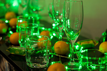 glasses and oranges in green light