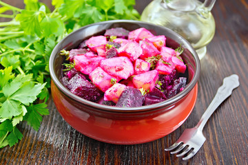 Salad of beets and potatoes in bowl on dark board