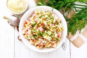 Salad of surimi and eggs with mayonnaise on wooden board top © kostrez