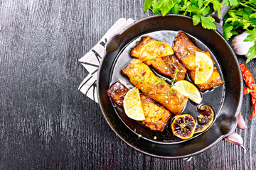 Salmon with sauce in pan on board top