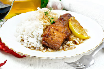 Salmon with sauce in plate on wooden board