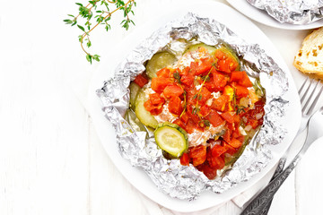 Salmon with vegetables in plate on board top