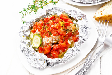 Salmon with vegetables in plate on board