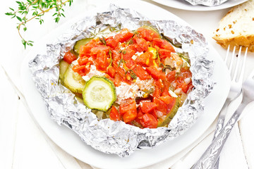 Salmon with vegetables in plate on white wooden board
