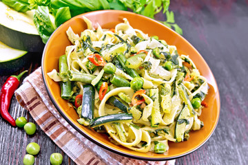 Tagliatelle with green vegetables on board
