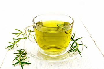 Tea of rosemary in cup on board