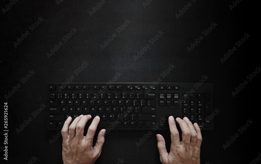 Poster top view, hand typing computer keyboard on black background