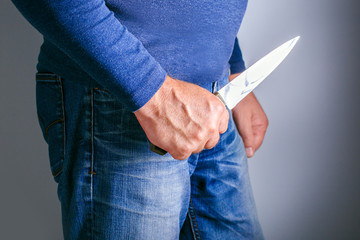 Harassment concept. Man With Knife Coming To His Wife. Home Violence Concept.