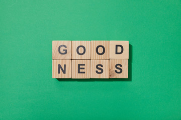 top view of wooden blocks with letters on green surface