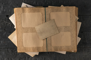 Open old photo album with one upside down photo. The subject of family values. The view from the...