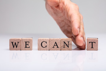 Person's Hand Separating 't' From The We Can Blocks