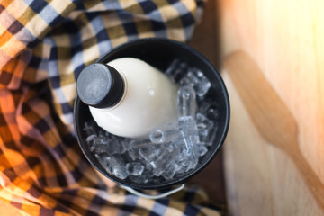 Bottles with fresh milk served in bucket