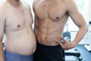 Fototapeta na wymiar Two naked men comparing belly fat and slim six pack