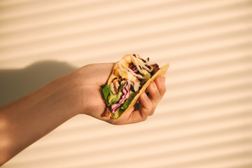 Traditional mexican taco with meat and vegetables. Latin american food.