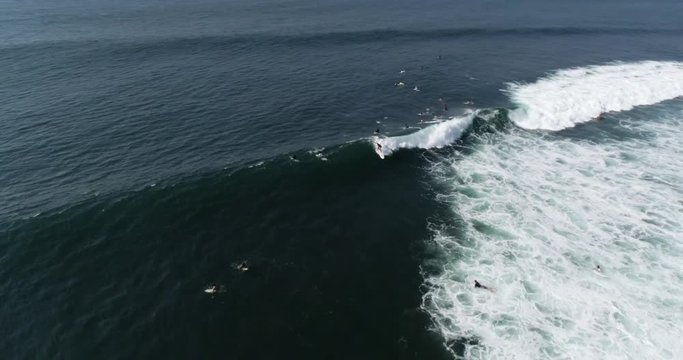 Surfer riding wave aerial video in tropical point break. 