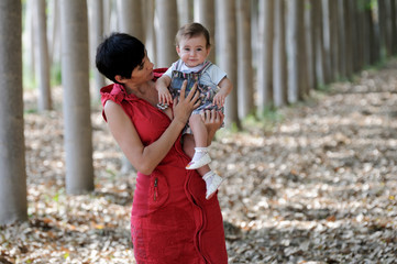 Mother and her little daughter in the forest