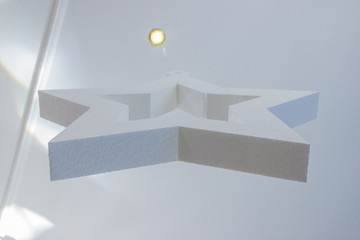 White decorative star made of styrofoam under the ceiling in the restautant