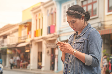 Asian girl traveller use smart phone for trip
