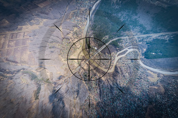 Close-up, a small town, a village with small houses, a river, a bridge, roads and other strategically important objects to be under the gun and shadowed. Concept of computer game and spying on people