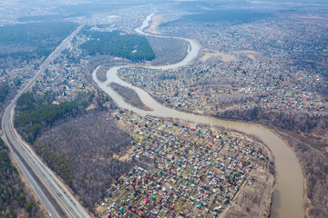 Aerial view, panorama: landscape of river, beach and forest, village with small houses and road.  top view of beautiful nature texture from drone