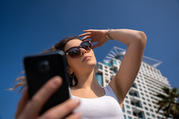 young woman using the phone. City Skyline In Background