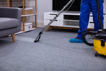 Male Janitor Cleaning Carpet