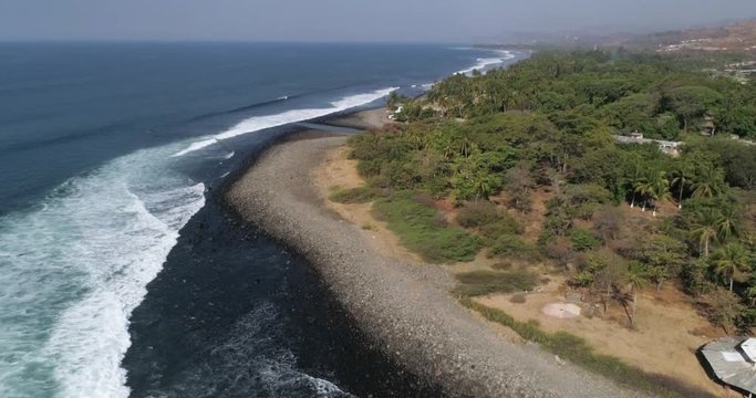 Tropical beach coastline in summer day. PALM TREES in SLOW Motion in El Salvador. Travel natural light aerial stock video with Airflow Creations leisure travel.