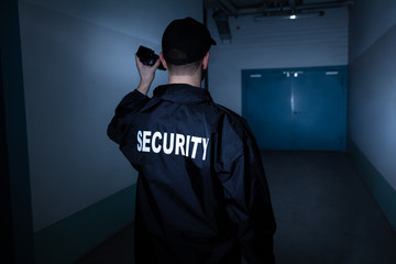 Male Security Guard Standing In Corridor