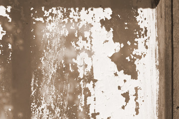 Old painted window behind iron bar close up. Grunge background in brown color