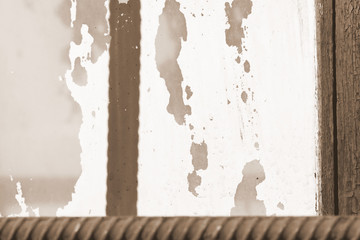 Old painted window behind iron bar close up. Grunge background in brown color