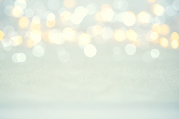 Magic twinkling holiday abstract glitter background with blinking lights and snow. Blurred bokeh of...