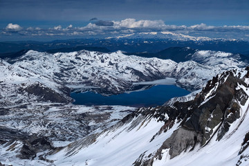 Mount St. Helens crater and Spirit lake with mount Rainier in the distance. Snow covered mountains view from Saint Helens crater rim. Seattle. Washington. United States of America