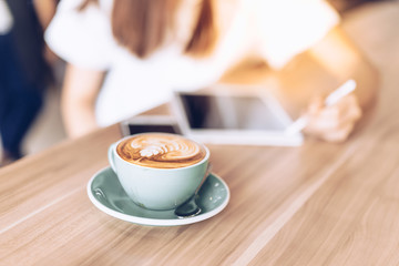 woman in a cafe drinking coffee .Portrait of Asian woman smiling in coffee shop cafe vintage color tone