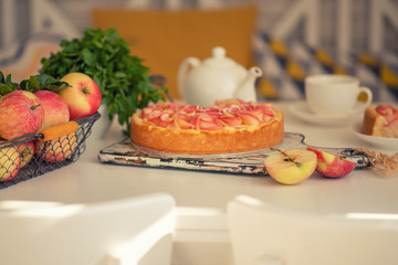 Homemade cheesecake with fresh apples and mint for dessert. Healthy organic summer dessert pie. Fresh fruit cake with homemade granola for healthy vegan diet vegetarian organic food.