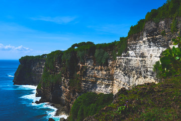 Fototapeta na wymiar Bali seascape with huge waves and beautiful rocks. Sea beach nature, outdoor Indonesia. Island landscape. Summer holidays at ocean beach. Travel vacation in Indonesia beach. Ecological tourism.