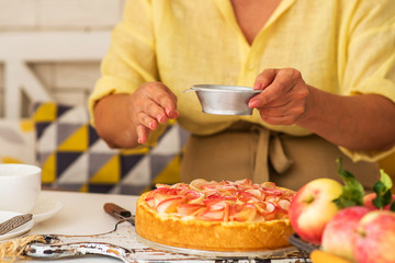 Woman make homemade apple pie. Confectioner make dessert. Apples on the table. Summer fruit dessert. Process of cooking apple pie, top view. Cooking and home concept.