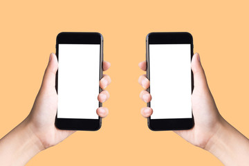 two hands holding smart phones on  yellow background with clipping path
