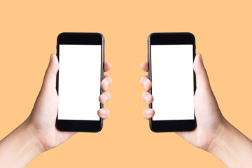 two hands holding smart phones on  yellow background with clipping path